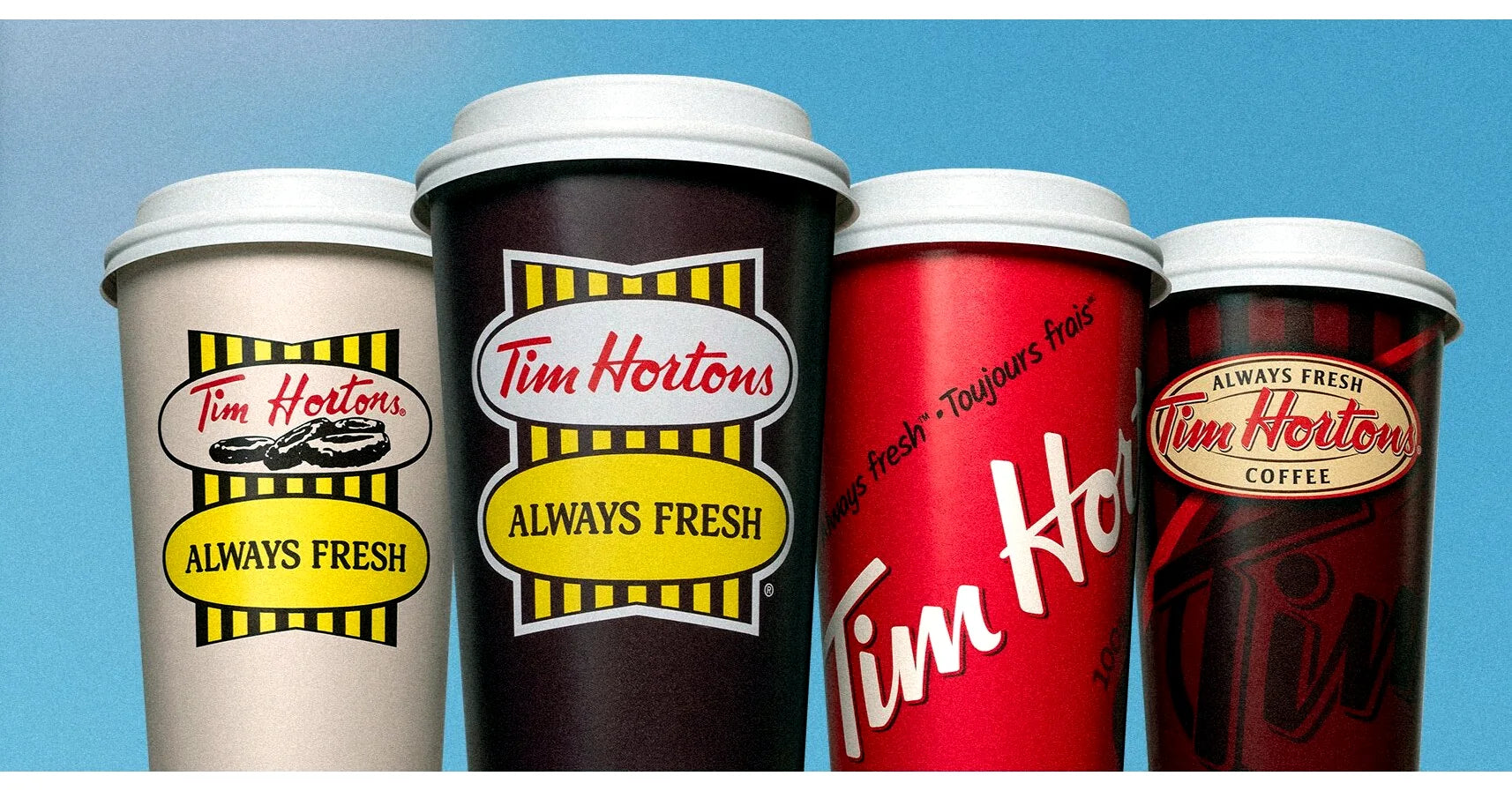 Four Tim Hortons coffee cups showing older and newer cup designs