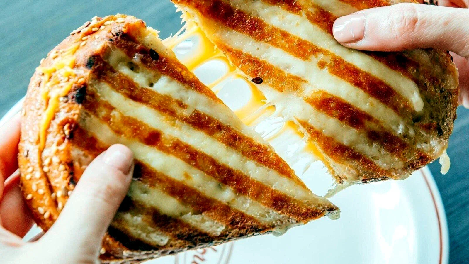 Grilled cheese sandwich being pulled apart