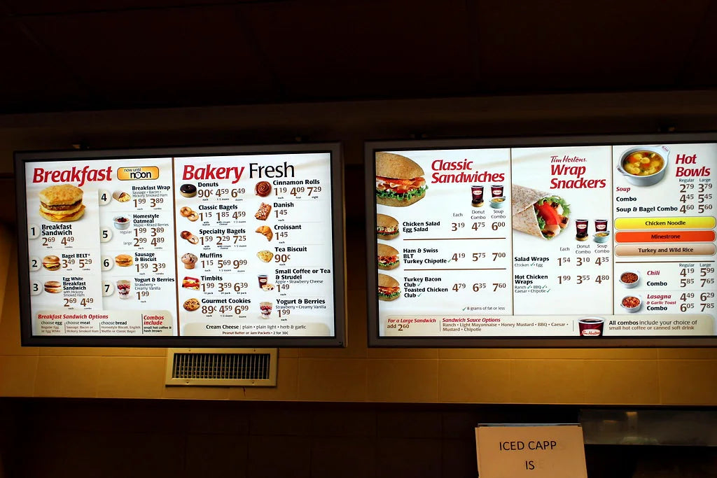 Old Tim Hortons menu board with breakfast, bakery, sandwiches, wraps, and hot bowls